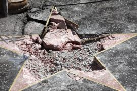 Workers remove the damaged remains of President Donald J. Trump's star on the Hollywood Walk of Fame after it was destroyed overnight in Hollywood section of Los Angeles, California, USA, 25 July 2018.