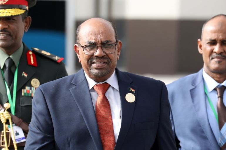 Sudan's President Omar al-Bashir walks with officials as he leaves the African Union (AU) summit in Nouakchott, Mauritania, July 2, 2018. Ludovic Marin/Pool via Reuters