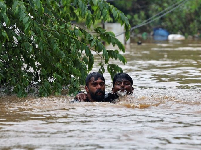 A man rescues a drowning man from a flooded area after the opening of Idamalayr, Cheruthoni and Mullaperiyar dam shutters following heavy rains, on the outskirts of Kochi, India August 16, 2018. REUTERS/Sivaram V TPX IMAGES OF THE DAY