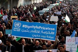 Palestinian employee of United Nations Relief and Works Agency (UNRWA) hold a sign during a protest against a U.S. decision to cut aid, in Gaza City January 29, 2018. REUTERS/Mohammed Salem