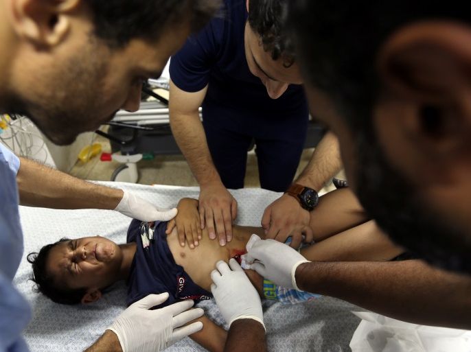 ATTENTION EDITORS - VISUAL COVERAGE OF SCENES OF INJURY OR DEATH A Palestinian boy, who was wounded during a protest at the Israel-Gaza border, is treated at a hospital in the southern Gaza Strip August 10, 2018. REUTERS/Ibraheem Abu Mustafa TEMPLATE OUT
