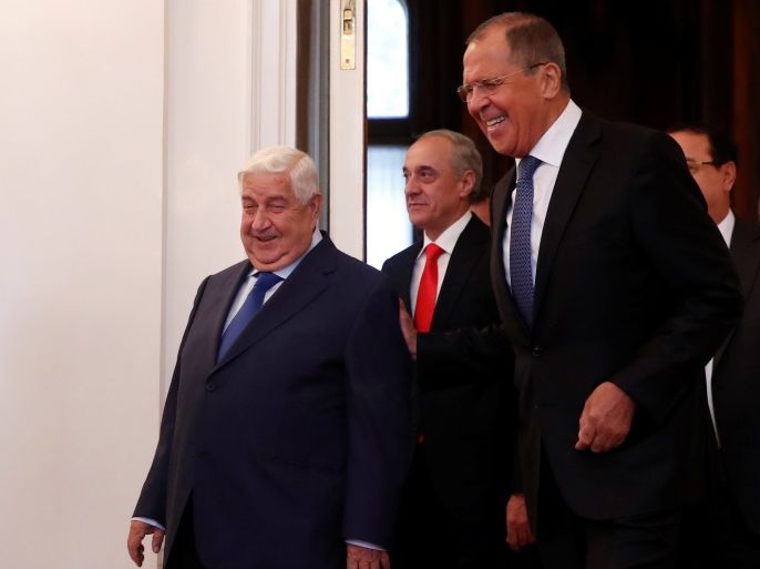 Russian Foreign Minister Sergei Lavrov and Syrian Foreign Minister Walid al-Moualem enter a hall for their talks in Moscow, Russia August 30, 2018. REUTERS/Maxim Shemetov