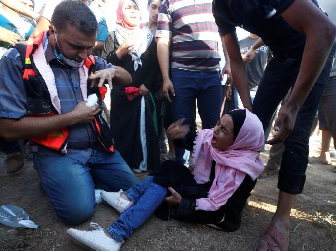 ATTENTION EDITORS - VISUAL COVERAGE OF SCENES OF INJURY OR DEATH A wounded Palestinian girl reacts during a protest demanding the right to return to their homeland at the Israel-Gaza border, in Gaza August 17, 2018. REUTERS/Mohammed Salem
