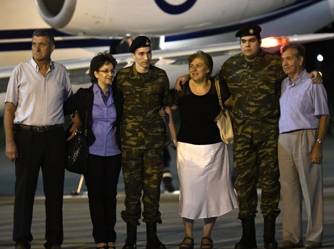 Angelos Mitretodis (L) and Dimitris Kouklatzis, two Greek soldiers who were detained in Turkey after crossing the border, are welcomed by their parents after being released, at the airport of Thessaloniki, Greece, August 15, 2018. REUTERS/Alexandros Avramidis