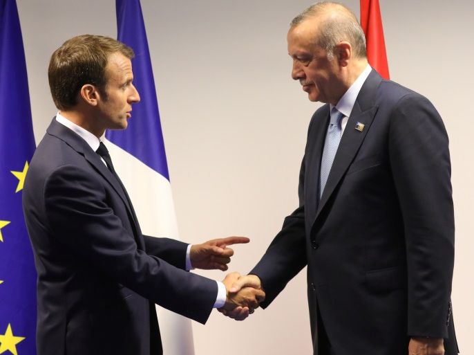 France's President Emmanuel Macron (L) shakes hands with Turkey's President Recep Tayyip Erdogan ahead of a bilateral meeting on the sidelines of the second day of the North Atlantic Treaty Organization (NATO) summit in Brussels, Belgium July 12, 2018. Ludovic Marin/Pool via REUTERS