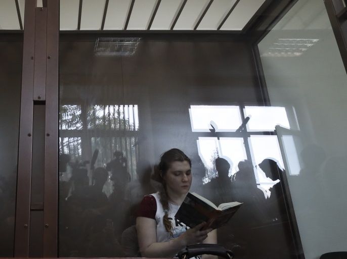 Anna Pavlikova, 18, one of two teenage girls detained among others on charges of involvement in extremist group 'Novoye Velichiye' (New Greatness), sits inside a glass-walled cage during a hearing at the Dorogomilovsky District Court in Moscow, Russia, 16 August 2018. The court considers investigators movement to release the girl from custody and transfer her under house arrest. Two teenagers, Anna Pavlikova and Maria Dubovik, who were arrested in March 2018, may face in case if found guilty from six to ten years in prison. EPA-EFE/SERGEI ILNITSKY