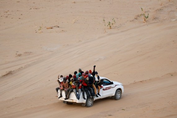 Migrants crossing the Sahara desert into Libya ride on the back of a pickup truck outside Agadez, Niger, May 9, 2016. Picture taken May 9, 2016. To match Analysis EUROPE-MIGRANTS/AFRICA REUTERS/Joe Penney