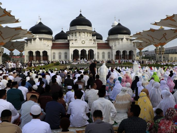 Eid el-Fitr Prayer in Aceh- - ACEH, INDONESIA - JUNE 15 : Muslims perform Eid al-Fitr prayer at Baiturrahman Grand Mosque, Aceh, Indonesia on June 15, 2018. Eid al-Fitr is a religious holiday celebrated by Muslims around the world that marks the end of Ramadan, Islamic holy month of fasting.