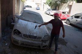 epa06991882 A man looks at a damaged car after rockets fired by unknown militants landed on the residential area of Ben Ashour, Tripoli, Libya, 01 September 2018 (issued 02 September 2018). According to reports, rockets hit several parts of Tripoli on 01 September including the Al-Waddan Hotel, which is only 100 meters away from the Italian embassy, and Ben Ashour area near prime minister’s office as fighting renewed between rival factions in the capital. At least 39 people, including civilians, were killed in the fresh clashes that erupted over the past few days. EPA-EFE/STR