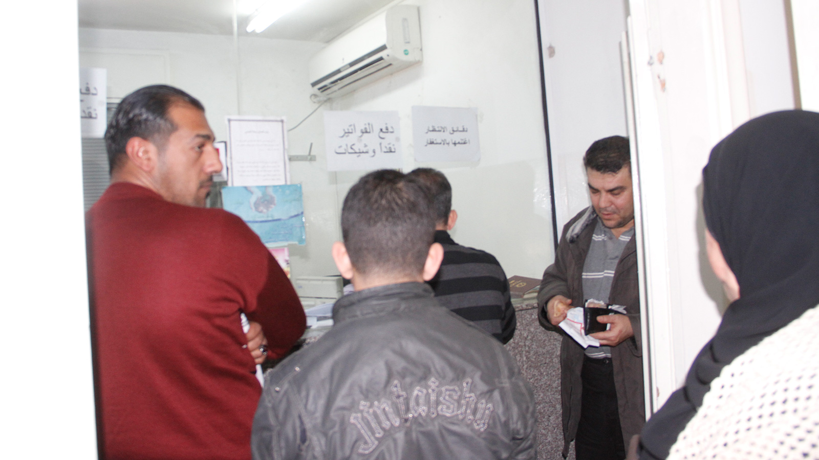 أردنيون يصطفون لدفع فواتير الكهرباء في أحد مكاتب شركة الكهرباء الأردنية (الجزيرة نت)
