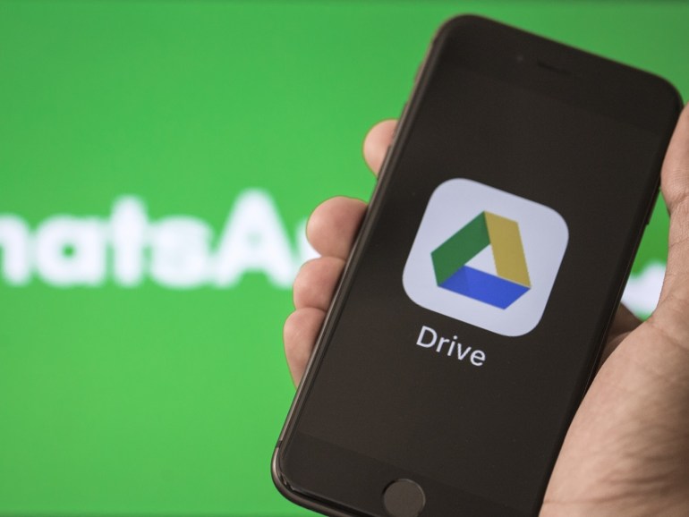 WhatsApp and Google Drive Applications- - ANKARA, TURKEY - AUGUST 28 : Logo of Google Drive application is seen in front of a screen displaying the WhatsApp logo on a screen in Ankara, Turkey on August 28, 2018.