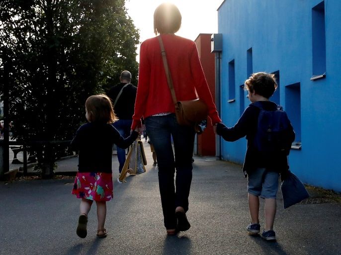 A mother and her children walk to arrive at the nursery school on the first day of the new school year in Vertou, France September 3, 2018. REUTERS/Stephane Mahe