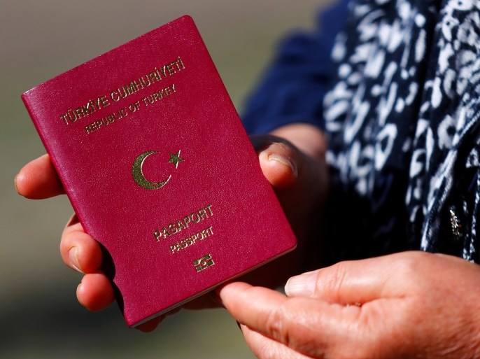 A Turkish voter, living in Germany, holds her passport to cast her vote on Turkey's presidential and parliamentary elections at the Turkish consulate in Berlin, Germany, June 7, 2018. REUTERS/Hannibal Hanschke