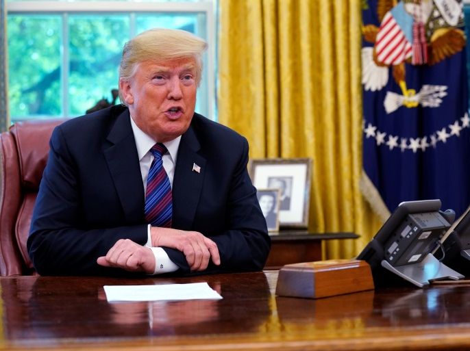 U.S. President Donald Trump speaks to Mexico's President Enrique Pena Nieto on the phone as he makes an announcemment on the status of the North American Free Trade Agreement (NAFTA) from the Oval Office of the White House in Washington, U.S., August 27, 2018. REUTERS/Kevin Lamarque