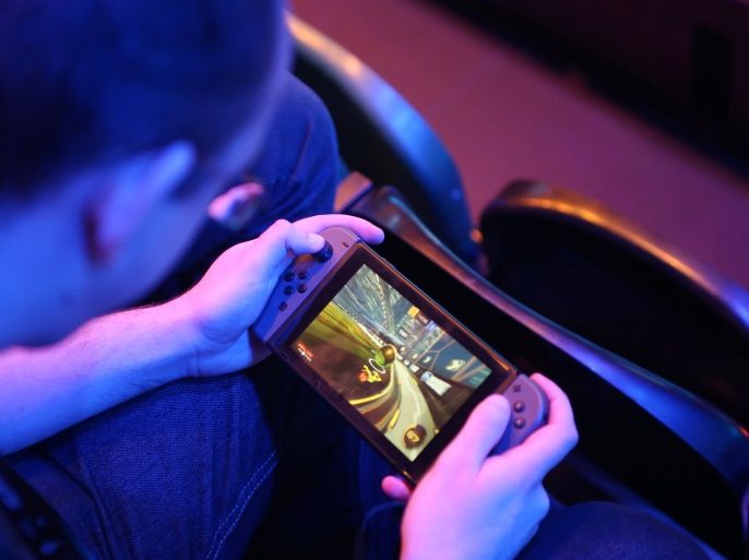 A fan plays Rocket League on a Nintendo Switch during day one of the Rocket League Championship Series Finals in London, Britain, June 8, 2018. REUTERS/Tom Jacobs