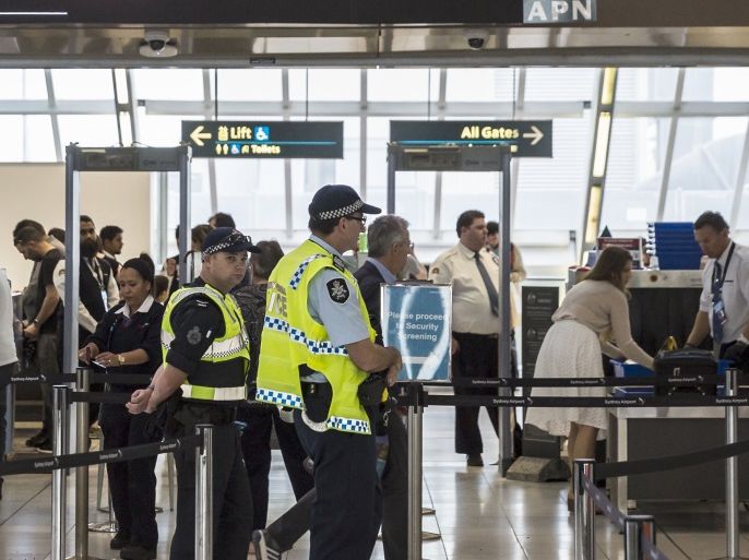 SYDNEY, NEW SOUTH WALES - JULY 30: Police guard the passenger security check area at Sydney Airport on July 30, 2017 in Sydney, Australia. Counter terrorism police raided four houses across Sydney on Saturday night and arrested four men over an alleged terror plot that involved blowing up an aircraft. Australian travellers have been warned to expect major delays at airports around the country with security screening measures ramped up following the raids. (Photo by Brook Mitchell/Getty Images)