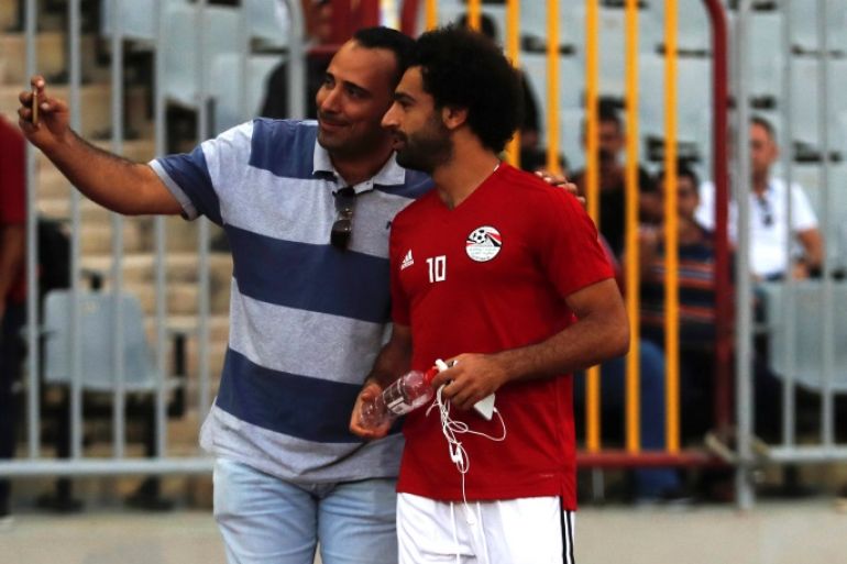 Soccer Football - African Nations Cup qualifiers - Egypt Training - Borg El Arab Stadium, Alexandria, Egypt - September 7, 2018 - Egypt's Mohamed Salah takes a selfie picture with a fan from his village before their last training for the African Nations Cup qualifiers against Niger. REUTERS/Amr Abdallah Dalsh