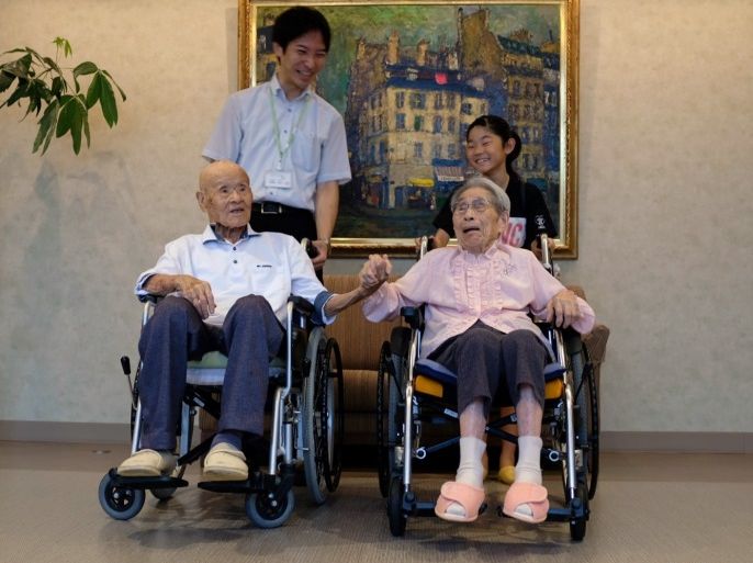 World's oldest living married couple Masao Matsumoto and Miyako Matsumoto pose for a photo with their great-grandchild and their care staff at a nursing house in Takamatsu, Kagawa prefecture, Japan September 4, 2018. REUTERS/Kwiyeon Ha