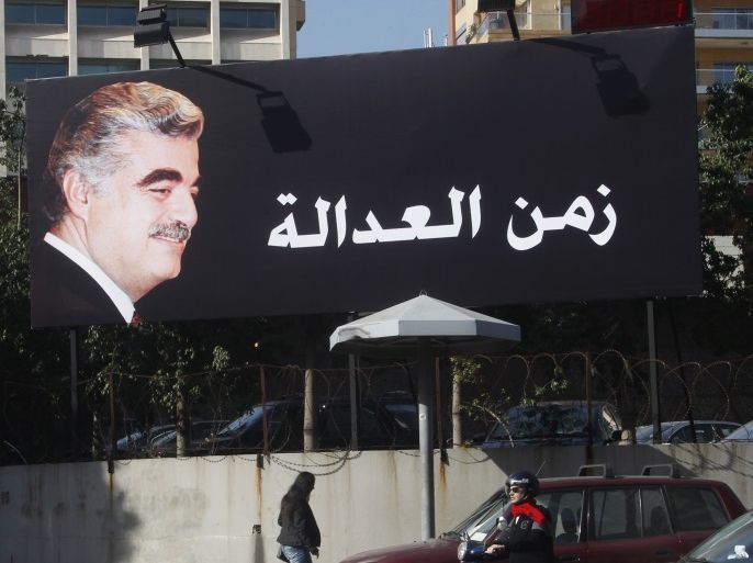 A billboard of former Prime Minister Rafik al-Hariri is displayed along a street in Beirut January 16, 2014. Nine years after the assassination of Lebanese statesman Rafik al-Hariri, the trial of four men accused of his killing opens on Thursday. But the defendants are on the run, bombers are back on Beirut streets and a new era of justice which the trial was meant to introduce to Lebanon remains elusive. Hariri and 21 other people were killed on the Beirut seafront in