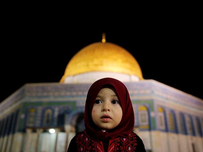 A Palestinian girl prays in front of the Dome of the Rock, at the compound known to Muslims as Noble Sanctuary and to Jews as The Temple Mount, in Jerusalem's Old City during the holy month of Ramadan June 7, 2016. REUTERS/ Ammar Awad TPX IMAGES OF THE DAY