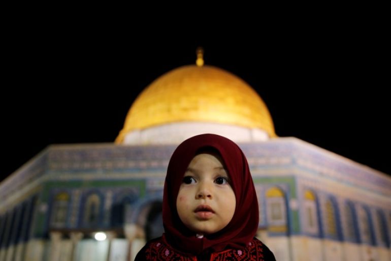 A Palestinian girl prays in front of the Dome of the Rock, at the compound known to Muslims as Noble Sanctuary and to Jews as The Temple Mount, in Jerusalem's Old City during the holy month of Ramadan June 7, 2016. REUTERS/ Ammar Awad TPX IMAGES OF THE DAY
