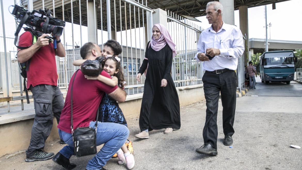 Syrian man comes together with his family after 3 years- - HATAY, TURKEY - OCTOBER 02: Syrian Enes Huleyf (2nd L) comes together with his family after 3 years of separation due to the civil war in Syria, at Cilvegozu Border Gate in Reyhanli district of Hatay, Turkey on October 02, 2018.