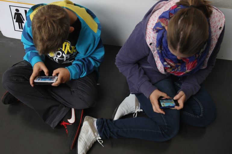 RUESSELSHEIM, GERMANY - SEPTEMBER 22: Children play video games on smartphones while attending a public event on September 22, 2012 in Ruesselsheim, Germany. Smartphones, with their access to social networks, high-resolution screens, video games and internet acess, have become commonplace among children and teenagers across the globe. (Photo by Sean Gallup/Getty Images)
