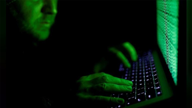 DUBAI (Reuters) - Hackers have attacked networks in a number of countries including data centers in Iran where they left the image of a U.S. flag on screens along with a warning: “Don’t mess with our elections”, the Iranian IT ministry said on Saturday. FILE PHOTO: A man types on a computer keyboard in front of the displayed cyber code in this illustration picture taken on March 1, 2017. REUTERS/Kacper Pempel/Illustration/File Photo