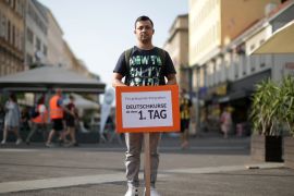 Almimar, 33, from Iraq poses with a banner ahead of a rally to protest for the rights of asylum seekers on World Refugee Day in Vienna, Austria June 20, 2018. REUTERS/Lisi Niesner