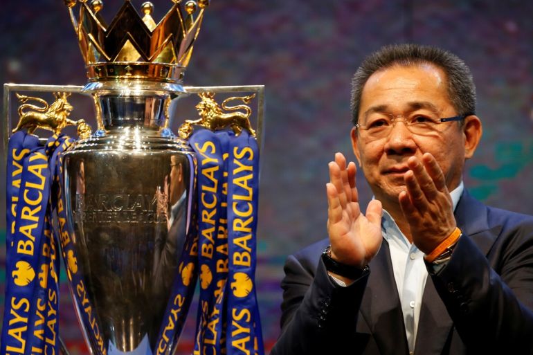 Vichai Srivaddhanaprabha, owner of football club Leicester City, stands on stage next to the club's English Premier League trophy during a meeting with the media in Bangkok, Thailand May 18, 2016. REUTERS/Jorge Silva