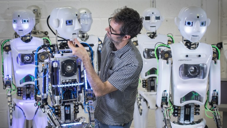 PENRYN, ENGLAND - MAY 09: Engineered Arts design and production engineer Marcus Hold works on a recently completed RoboThespian robot at the company's headquarters in Penryn on May 9, 2018 in Cornwall, England. Founded in 2004, the Cornish company operating from an industrial unit near Falmouth, is a world leader in life sized commercial available humanoid robots for entertainment, information, education and research. The company has successfully sold its the fully int