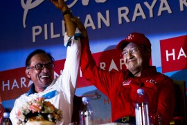 Mahathir Mohammad supports Anwar Ibrahim campaign in Malaysia- - PORT DICKSON, MALAYSIA - OCTOBER 8: Malaysian Prime Minister Tun Mahathir Mohamad (R) raises up Anwar Ibrahim's hand during by-election campaign, in Port Dickson, Malaysia on October 8, 2018. The support, given by Mahathir Mohamad as part of the agreement in the Pakatan Harapan Coalition (Alliance of Hope), decision to make him a Prime Minister within 2 years.
