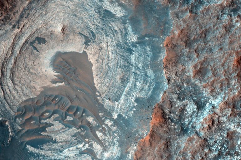 A circular depression on the surface of Mars is pictured in his image acquired on Jan. 5, 2015 by the High Resolution Imaging Science Experiment (HiRISE) camera on NASA's Mars Reconnaissance Orbiter (MRO), provided by NASA. The spacecraft has been orbiting Mars since March 2006 and completed its 40,000th orbit around Mars on Feb. 7, 2015. REUTERS/NASA/JPL-Caltech/University of Arizona/Handout