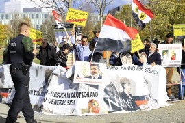 Protest against President of Egypt Abdel Fattah el-Sisi in Berlin- - BERLIN, GERMANY - OCTOBER 30: A group of protesters hold placards as they stage a protest against President of Egypt Abdel Fattah el-Sisi outside the Chancellery during his meeting with German Chancellor Angela Merkel in Berlin, Germany on October 30, 2018.