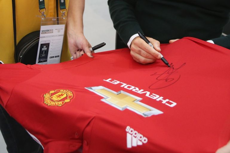 MANCHESTER, ENGLAND - SEPTEMBER 05: Juan Mata of Manchester United signs a shirt in the La Liga lounge during day 2 of the Soccerex Global Convention at Manchester Central Convention Complex on September 5, 2017 in Manchester, England. (Photo by Barrington Coombs/Getty Images for Soccerex)