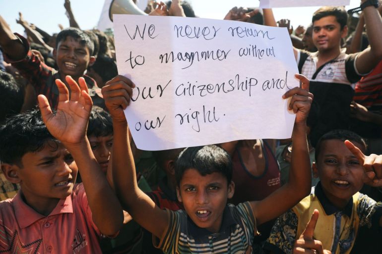 A boy holds a placard as hundreds of Rohingya refugees protest against their repatriation at the Unchiprang camp in Teknaf, Bangladesh November 15, 2018. REUTERS/Mohammad Ponir Hossain