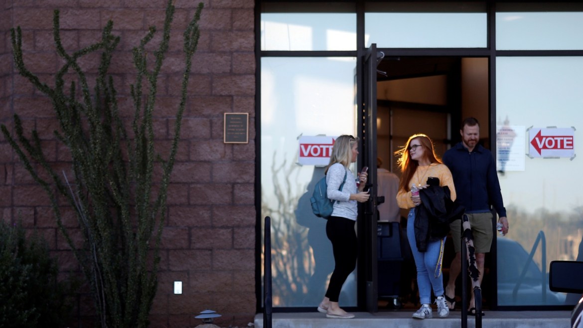 Victoria Leach, 18,  talks with her parents Tricia Leach and Marc Leach after voting during the midterm election at a polling station in Carefree, Arizona, U.S. November 6, 2018. REUTERS/Nicole Neri