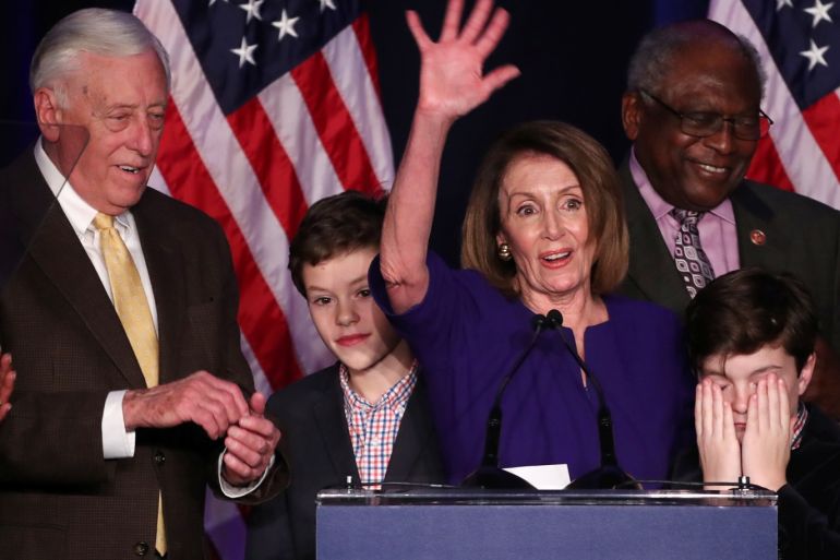 U.S. House Minority Leader Nancy Pelosi's grandson Paul covers his eyes as he and his brother Thomas (2nd L) join with their grandmother as well as House Minority Whip Steny Hoyer (L) and U.S. Rep. James Clyburn (R) as the Democrats celebrate winning a majority in the U.S. House of Representatives in the U.S. midterm elections in Washington, U.S. November 6, 2018. REUTERS/Jonathan Ernst