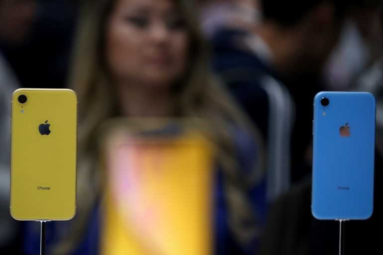 CUPERTINO, CA - SEPTEMBER 12: A visitor inspects the new Apple iPhone XR during an Apple special event at the Steve Jobs Theatre on September 12, 2018 in Cupertino, California. Apple released three new versions of the iPhone and an update Apple Watch. Justin Sullivan/Getty Images/AFP== FOR NEWSPAPERS, INTERNET, TELCOS & TELEVISION USE ONLY ==