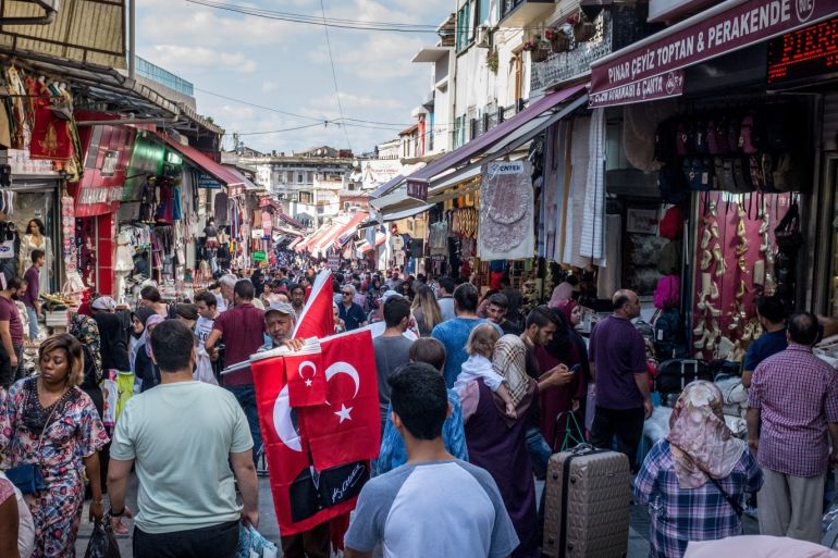 ISTANBUL, TURKEY - AUGUST 16: A man sells Turkish flags amongst crowds of shoppers on a market street on August 16, 2018 in Istanbul, Turkey. In an attempt to reassure investors Turkey's Finance minister Berat Albayrak held a conference call with thousands of international investors and pledged to fix the countries currency crisis. The Lira recovered to trade just under 6.0 to the dollar after record low's earlier in the week. (Photo by Chris McGrath/Getty Images)
