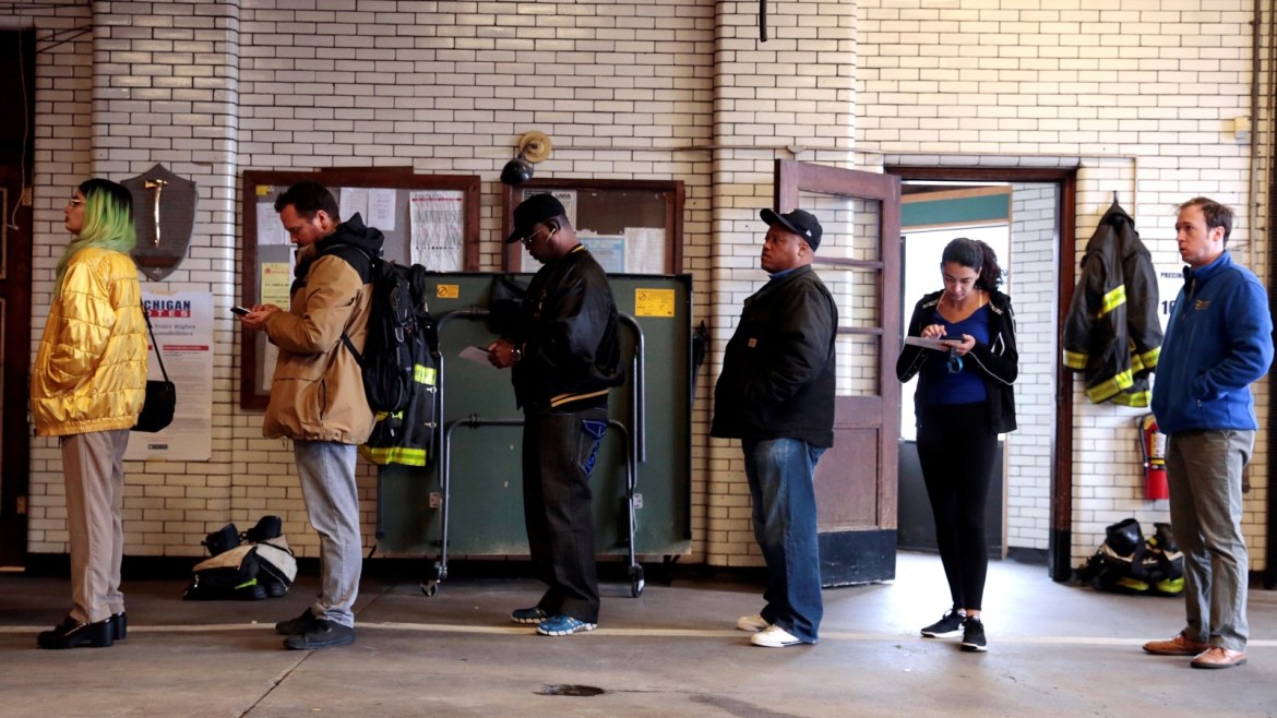 Voters wait to cast their ballots at a fire station serving as a voting place for the midterm election in Detroit, Michigan, U.S. November 6, 2018. REUTERS/Rebecca Cook