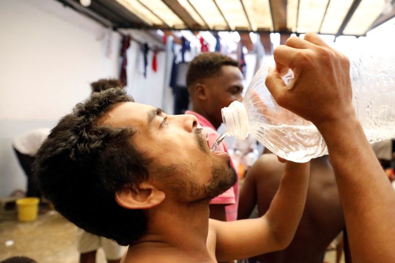 A migrant drinks water at the centre of the Anti-Illegal Immigration Authority in Tripoli, Libya September 10, 2017. REUTERS/Hani Amara