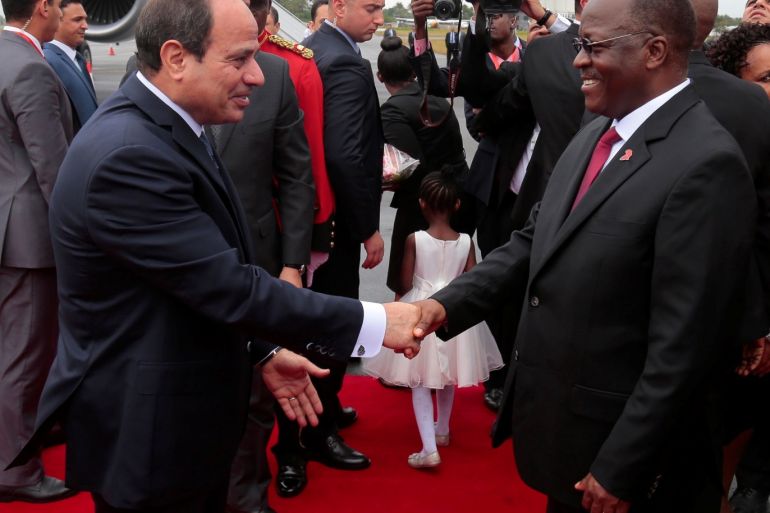 Egyptian President Abdel Fattah al-Sisi (L) is received by Tanzania's President John Magufuli at the Julius Nyerere International Airport in Dar es Salaam, Tanzania August 14, 2017. REUTERS/Emmanuel Herman