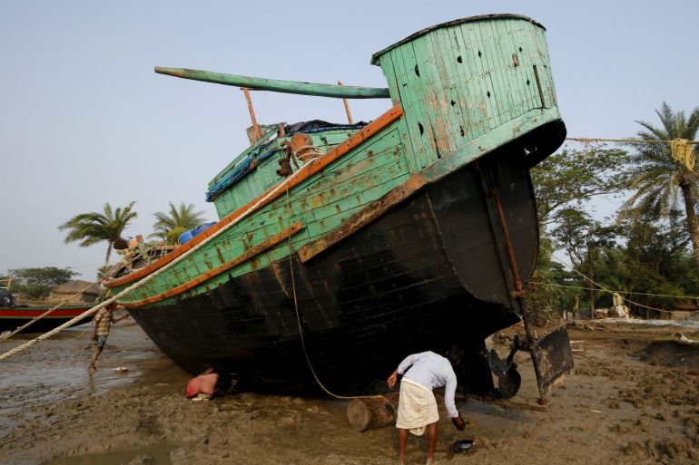Workers repair a boat along the coastline on Ghoramara Island, India, October 24, 2018. Ghoramara Island, part of the Sundarbans delta on the Bay of Bengal, has nearly halved in size over the past two decades, according to village elders. REUTERS/Rupak De Chowdhuri SEARCH