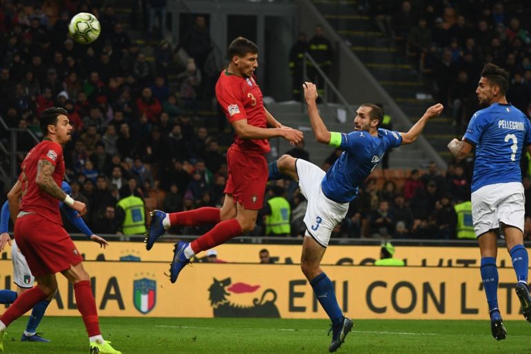 MILAN, ITALY - NOVEMBER 17: Giorgio Chiellini of Italy competes for the ball with Ruben Dias of Portugal during the UEFA Nations League A group three match between Italy and Portugal at Stadio Giuseppe Meazza on November 17, 2018 in Milan, Italy. (Photo by Claudio Villa/Getty Images)