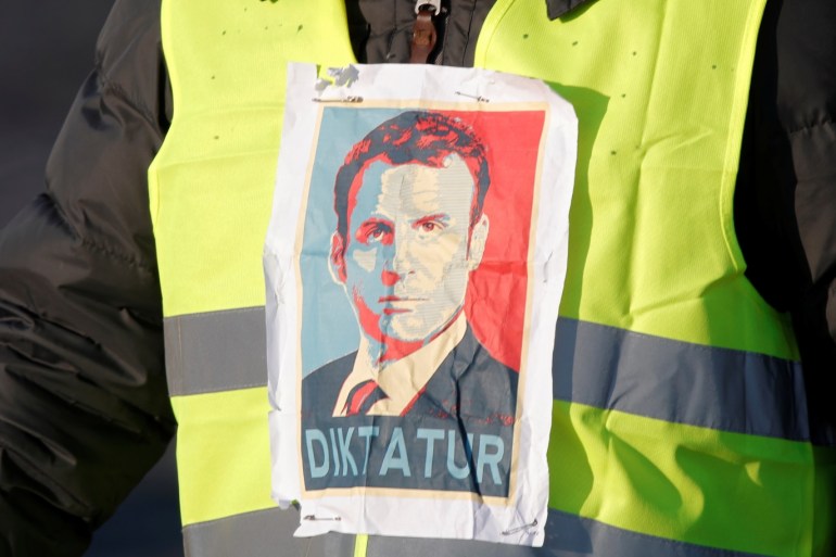 A man wearing a yellow vest, a symbol of a French drivers' protest against higher fuel prices, attends the demonstration with an image of French president Emmanuel Macron, in Paris, France, November 17, 2018. REUTERS/Charles Platiau