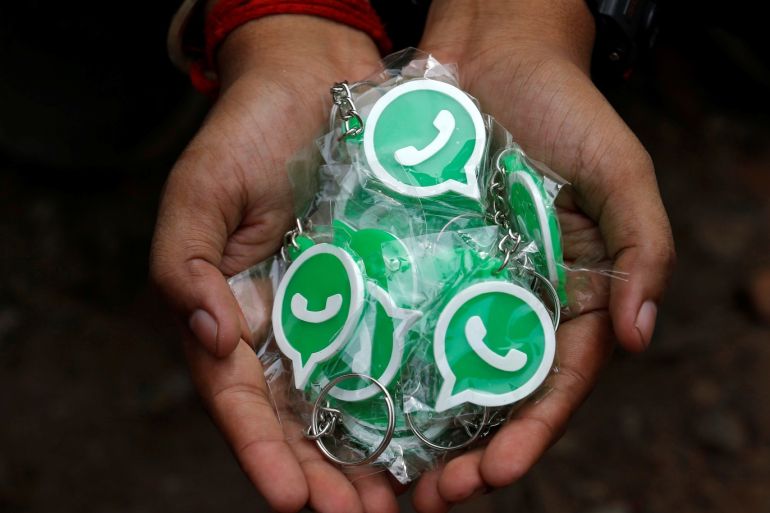 A WhatsApp-Reliance Jio representative displays key chains with the logo of WhatsApp for distribution during a drive by the two companies to educate users, on the outskirts of Kolkata, India, October 9, 2018. Picture taken October 9, 2018. REUTERS/Rupak De Chowdhuri