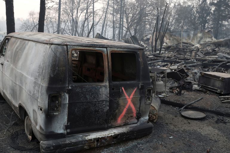 A van marked by search crews is seen in the aftermath of the Camp Fire in Paradise, California, U.S., November 17, 2018. REUTERS/Terray Sylvester