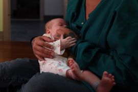 Social worker Angela Davis (L), looks on as Cassie, who declined to offer her surname, sits with her baby, Georgia, at Lily's Place, a treatment for babies suffering for Neonatal Abstinence Syndrome in Huntington, West Virginia, U.S. on June 20, 2017. Picture taken June 20, 2017. To match Special Report USA-HEALTHCARE/OPIOIDS REUTERS/Bryan Woolston