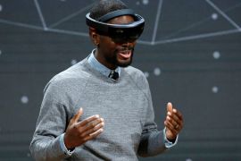 Taj Reid, Senior Designer at Microsoft wears a HoloLens VR headset at Microsoft's Windows 10